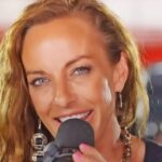 Tayla Lynn performing live on stage with country music vibe.